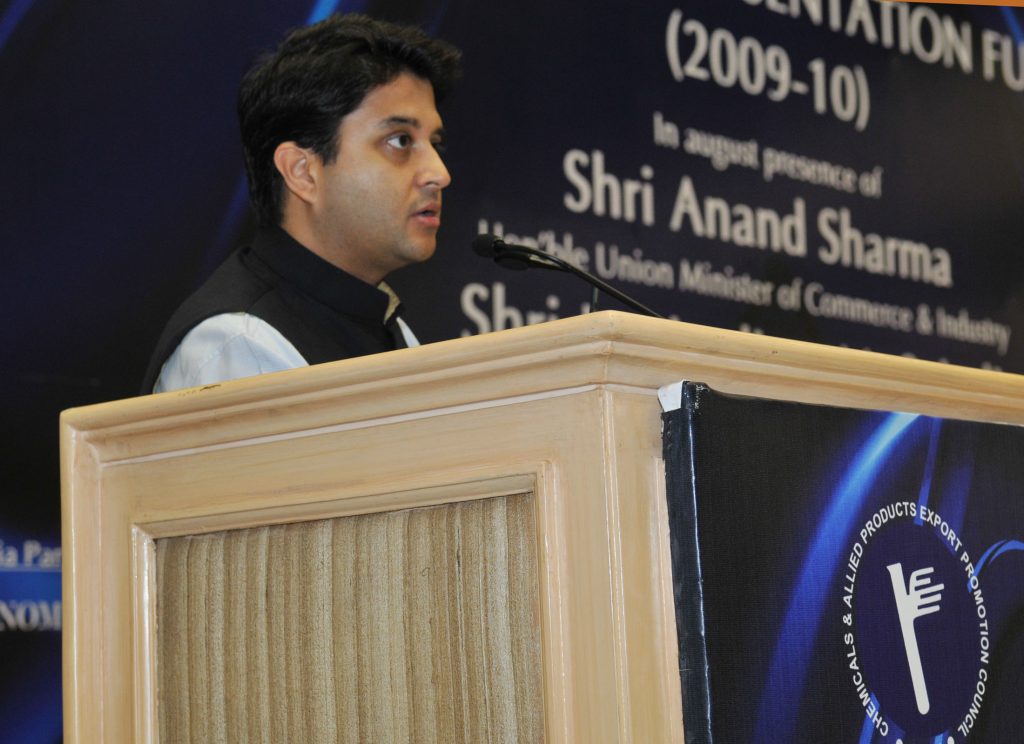 Jyotiraditya Scindia in a dark bandhgala speaking at a lectern