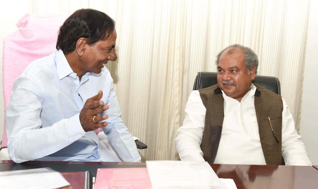 K. Chandrashekar Rao in white seated in conversation with Union Minister Narendra Singh Tomar