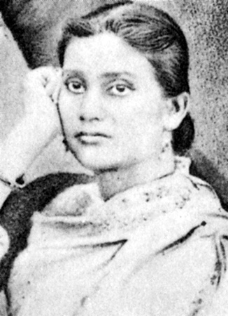 A black-and-white portrait of a young Kadambini Ganguly resting her head on her hand