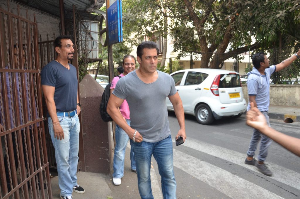 Salman Khan standing outdoors in a grey T-shirt