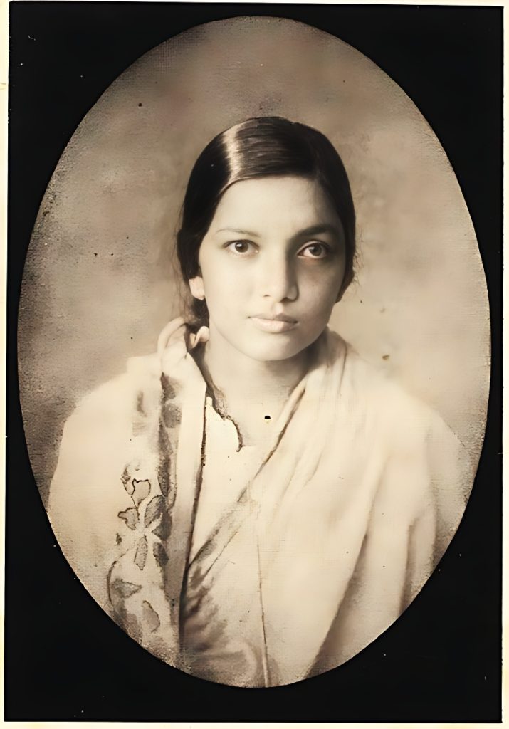 Oval sepia portrait of a young Kalpana Datta in a sari