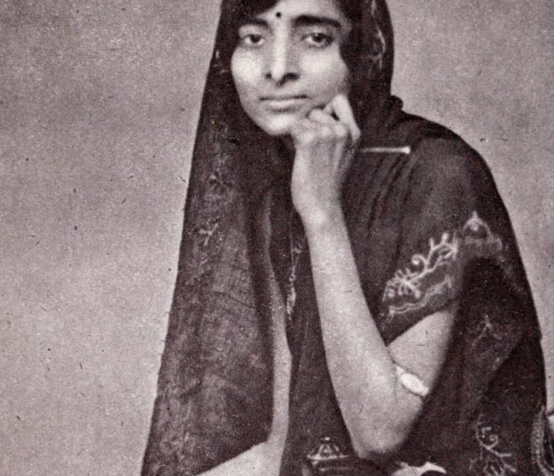 A black-and-white photograph of Kamala Nehru seated, her head covered with her sari