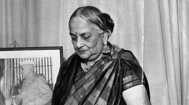A black-and-white photograph of Kamaladevi Chattopadhyay in a sari, looking down
