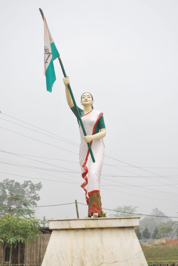 A statue of Kanaklata Barua holding the national flag