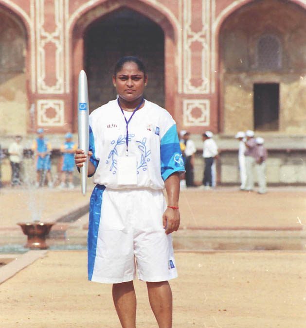 Karnam Malleswari holding the Olympic torch during a relay in New Delhi