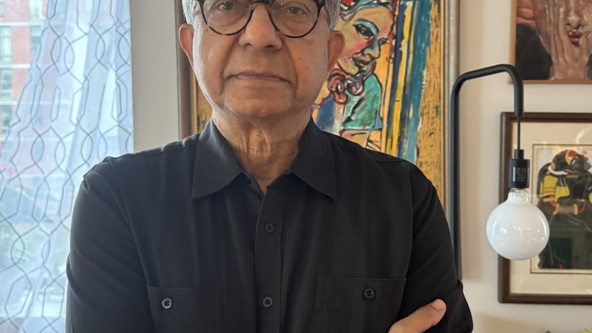 Kaushik Basu in glasses seated in his office