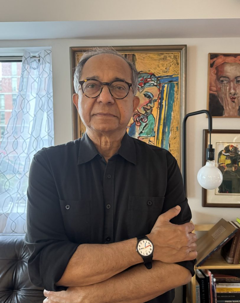 Kaushik Basu in glasses seated in his office
