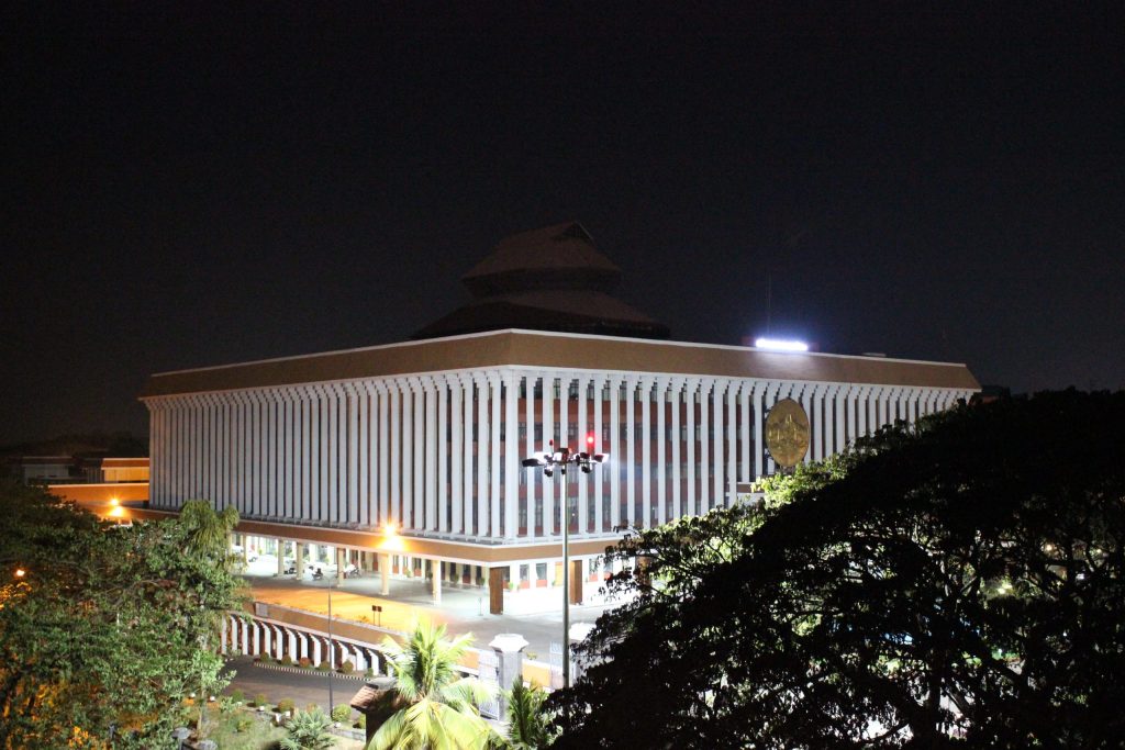The Kerala Legislative Assembly building lit up at night in Thiruvananthapuram