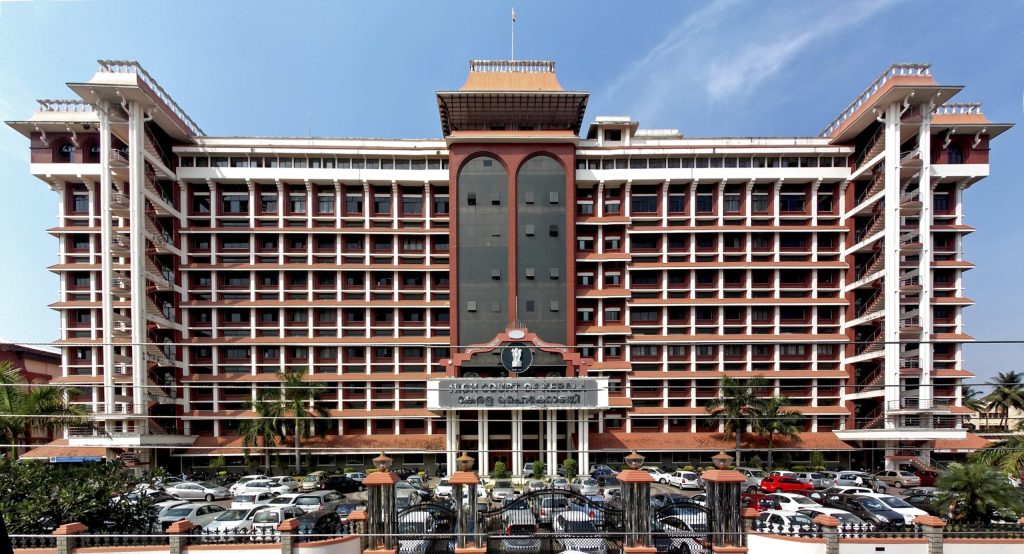 The Kerala High Court building in Ernakulam with its red and white facade