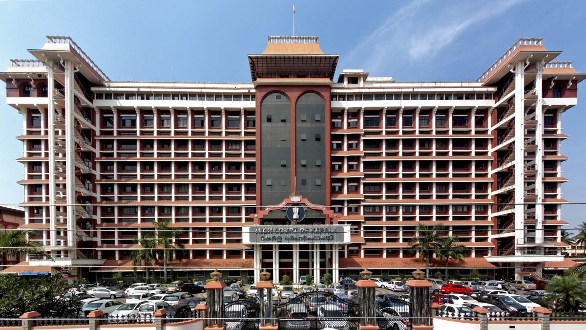 The Kerala High Court building in Ernakulam with its red and white facade