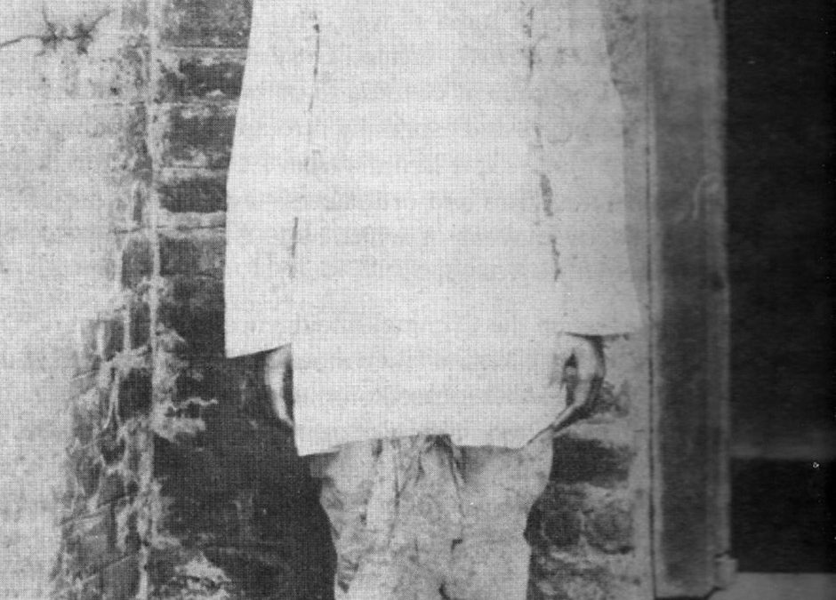 Full-length photograph of the teenage Khudiram Bose standing in a white shirt and dhoti