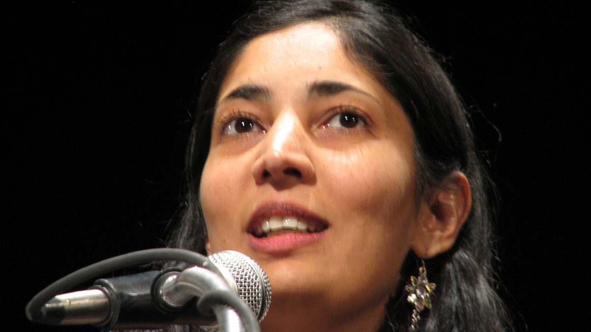 Close-up of Kiran Desai looking upward as she speaks at a microphone
