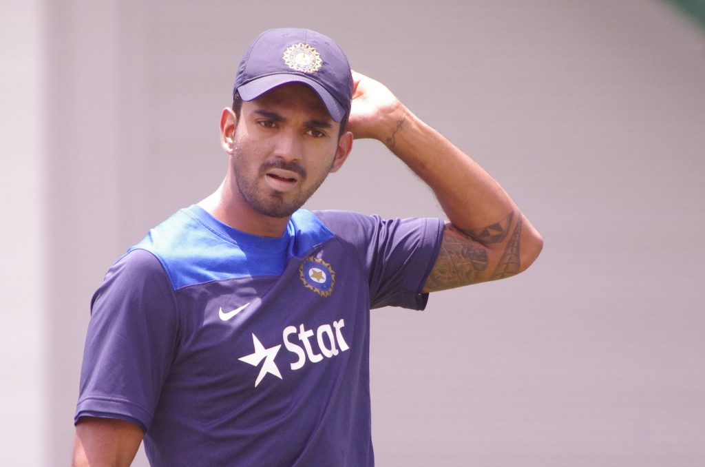 KL Rahul in a blue India training shirt and cap with his hand on his head
