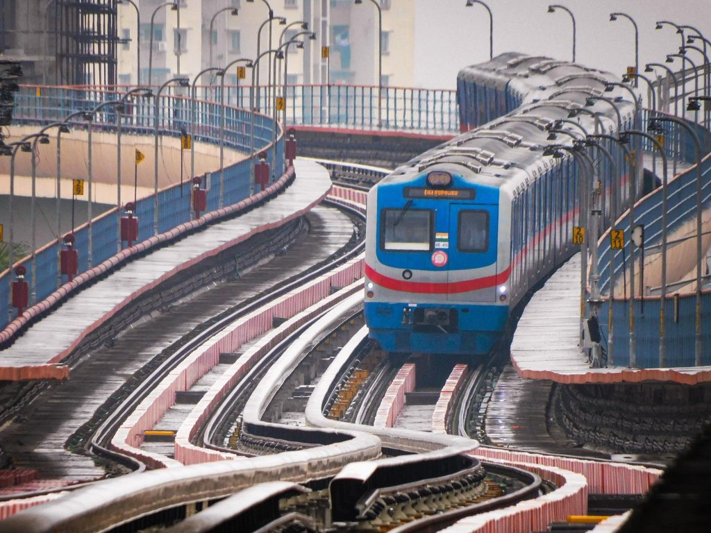 An Orange Line metro train of Kolkata Metro on an elevated section