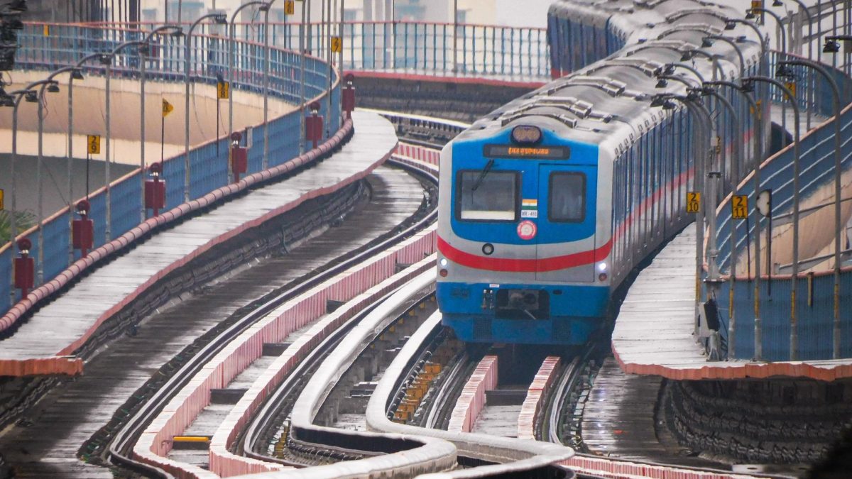 An Orange Line metro train of Kolkata Metro on an elevated section