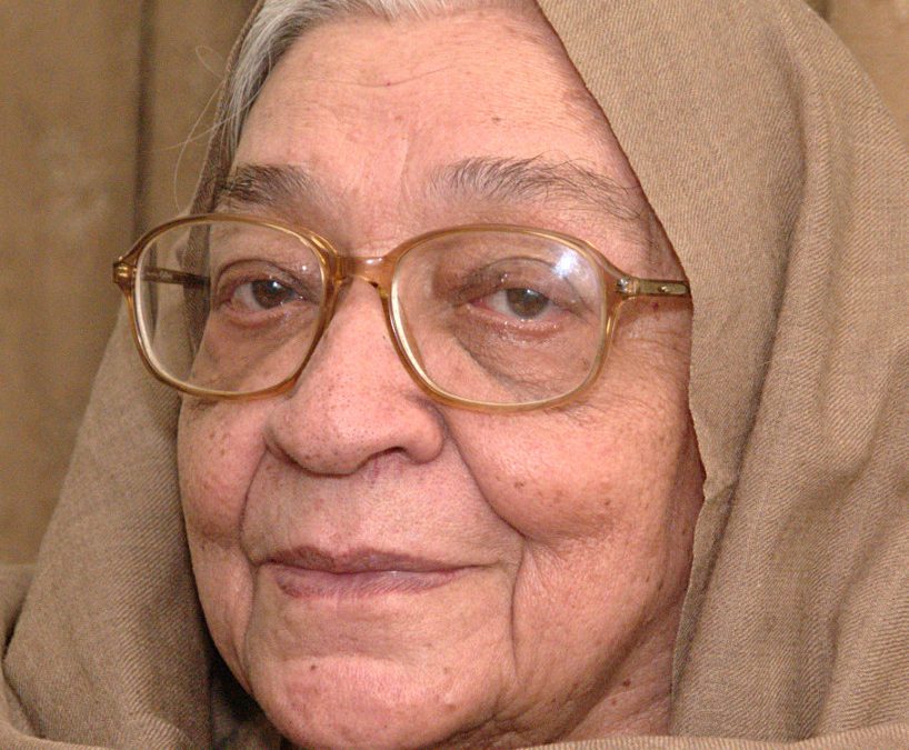Krishna Sobti in glasses, her head covered with a shawl