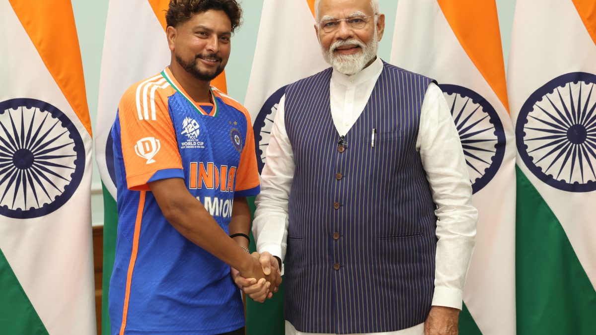 Kuldeep Yadav in India's champions jersey shaking hands with Prime Minister Narendra Modi