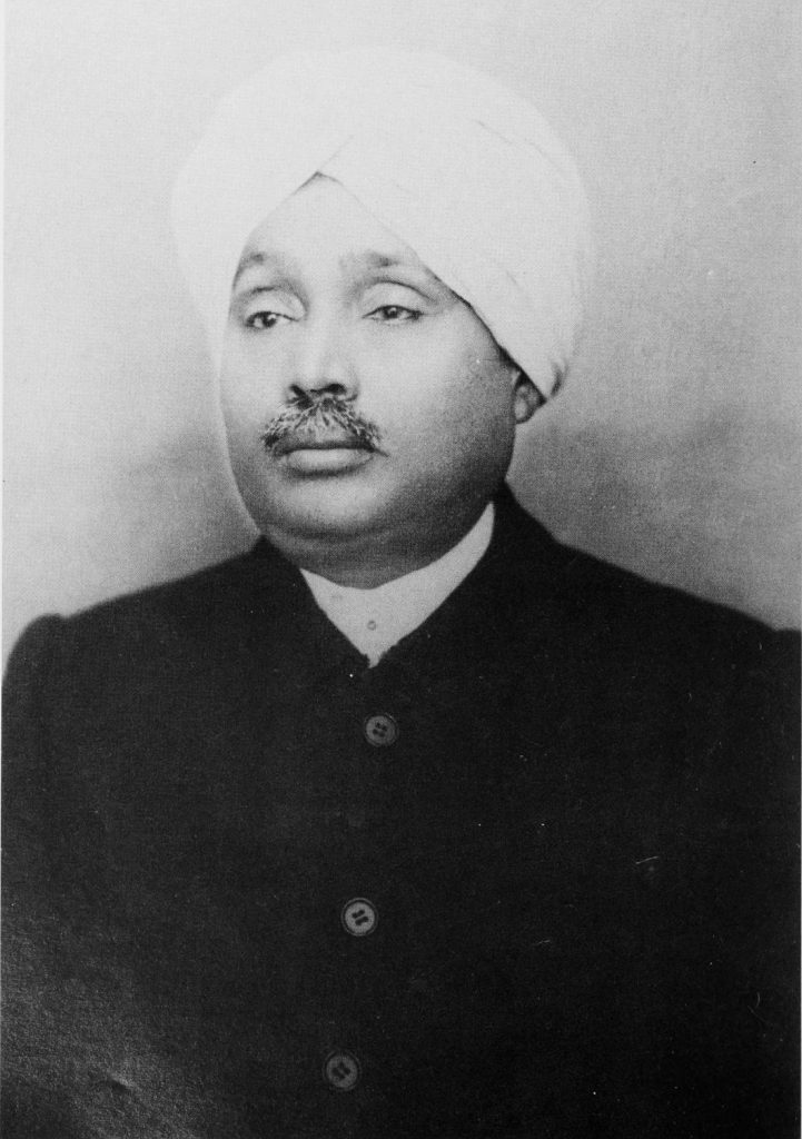 A black-and-white portrait of Lala Lajpat Rai in a turban and coat