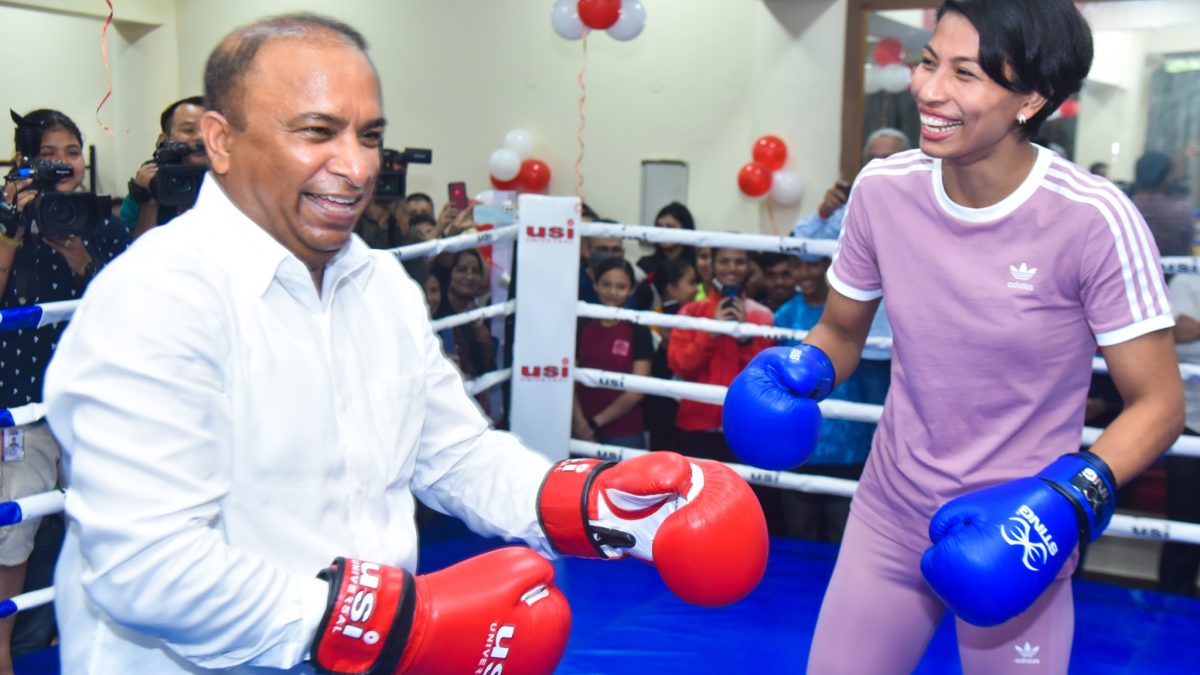 Lovlina Borgohain smiling in boxing gloves in a ring with an official