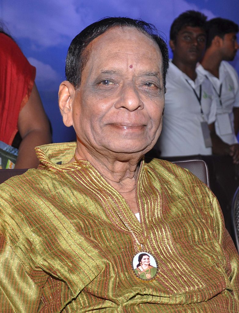M. Balamuralikrishna with white hair, in a silk shirt