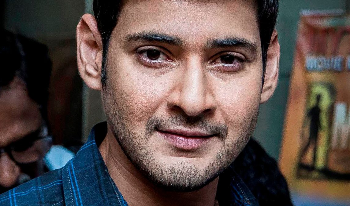 Close-up portrait of Mahesh Babu smiling in a checked shirt
