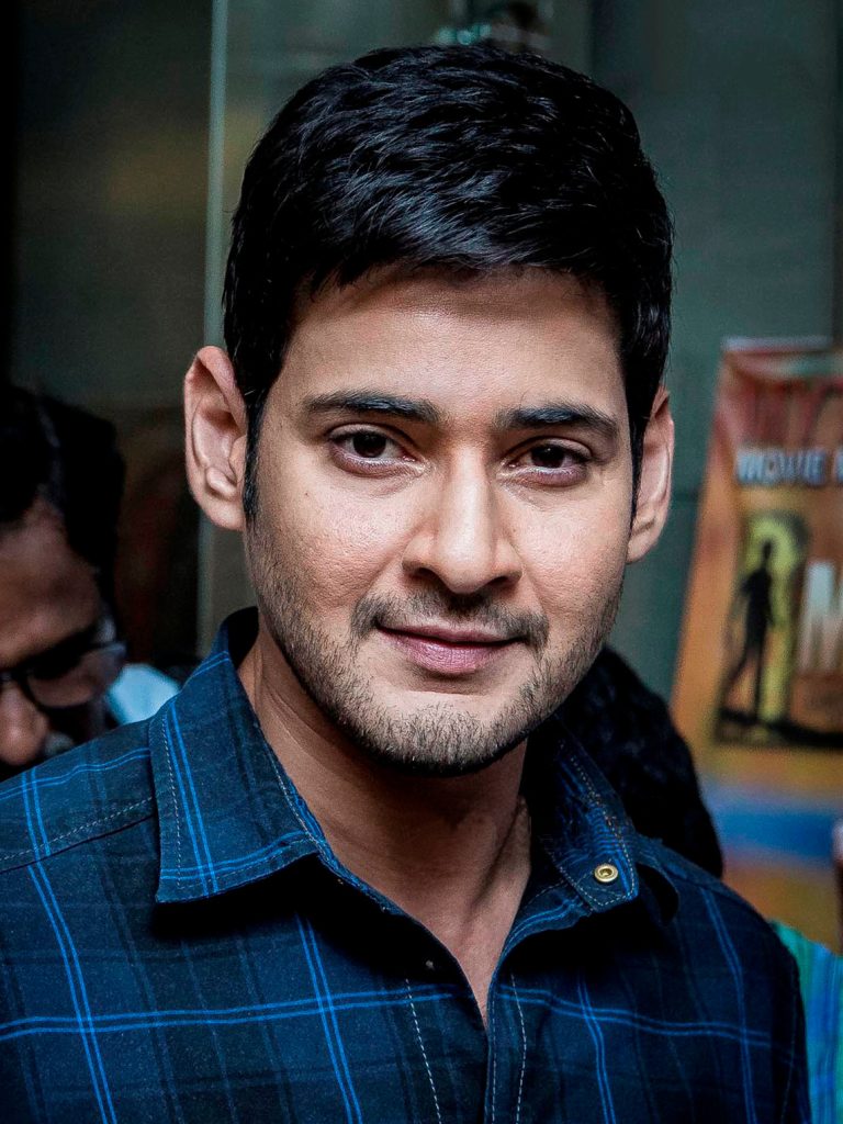 Close-up portrait of Mahesh Babu smiling in a checked shirt