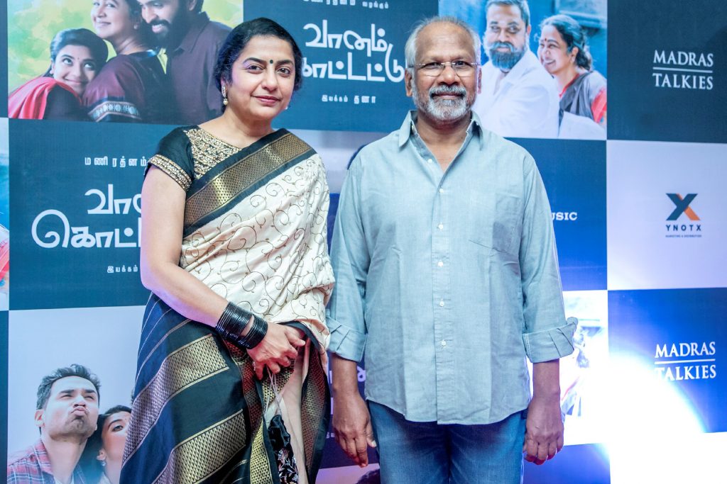 Mani Ratnam in a blue shirt standing beside his wife Suhasini at a film event