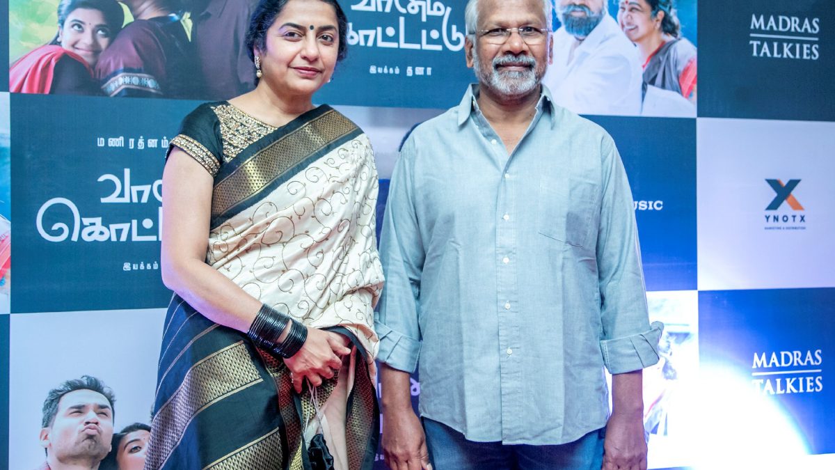 Mani Ratnam in a blue shirt standing beside his wife Suhasini at a film event