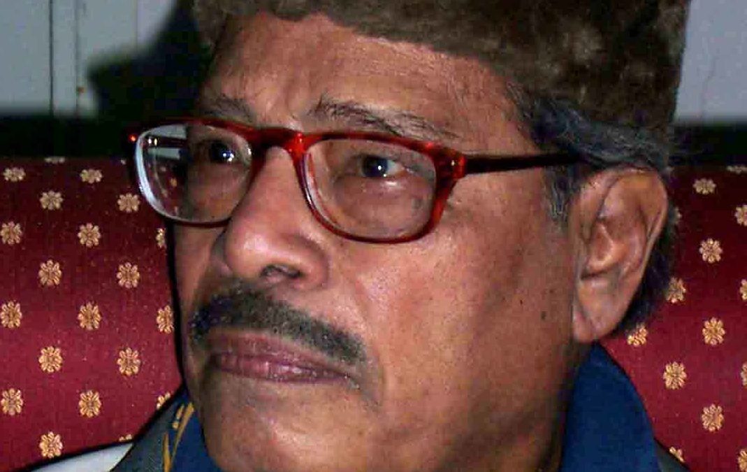 Manna Dey in a cap and glasses, wearing academic robes