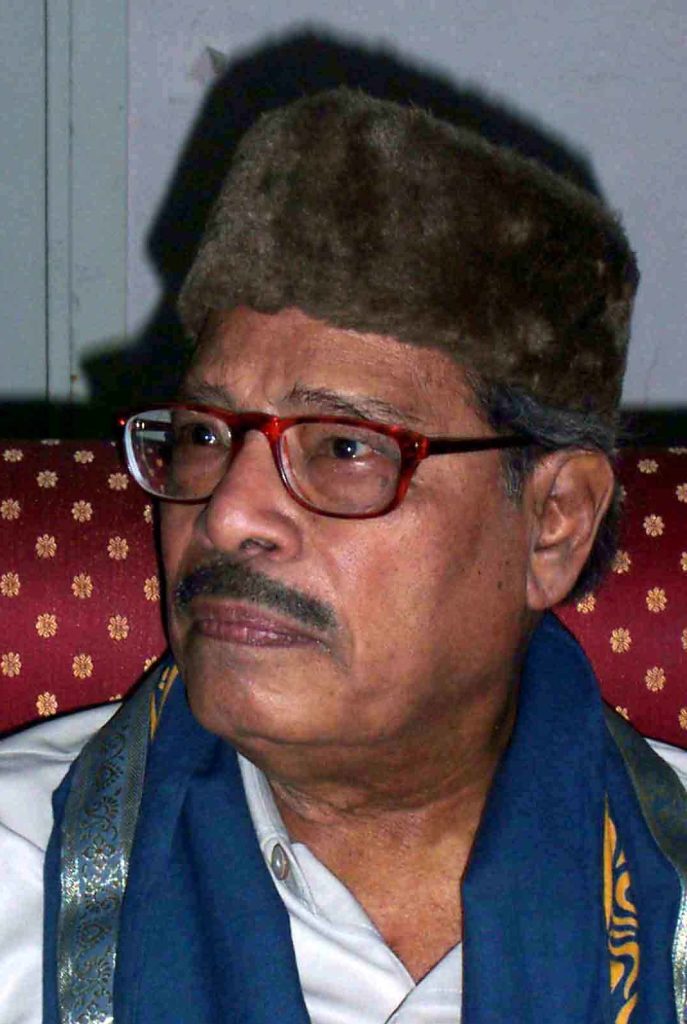 Manna Dey in a cap and glasses, wearing academic robes