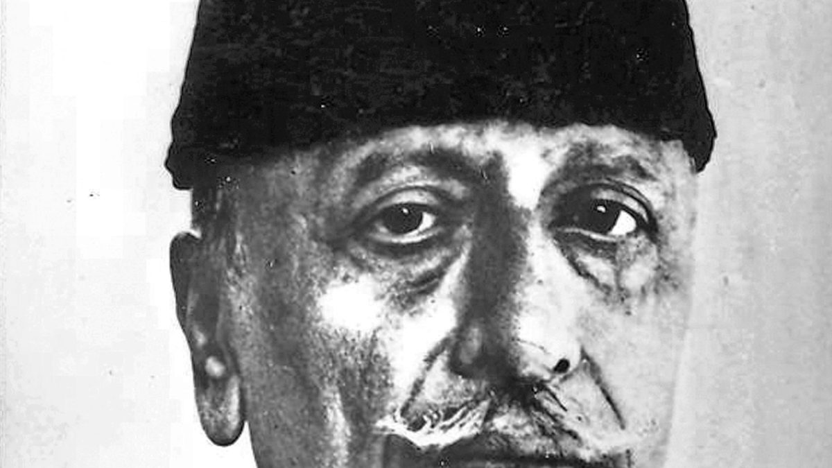 A black-and-white portrait of Maulana Abul Kalam Azad in a tall cap