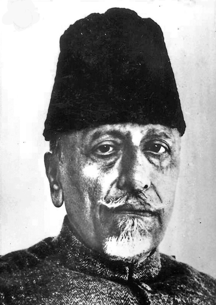 A black-and-white portrait of Maulana Abul Kalam Azad in a tall cap