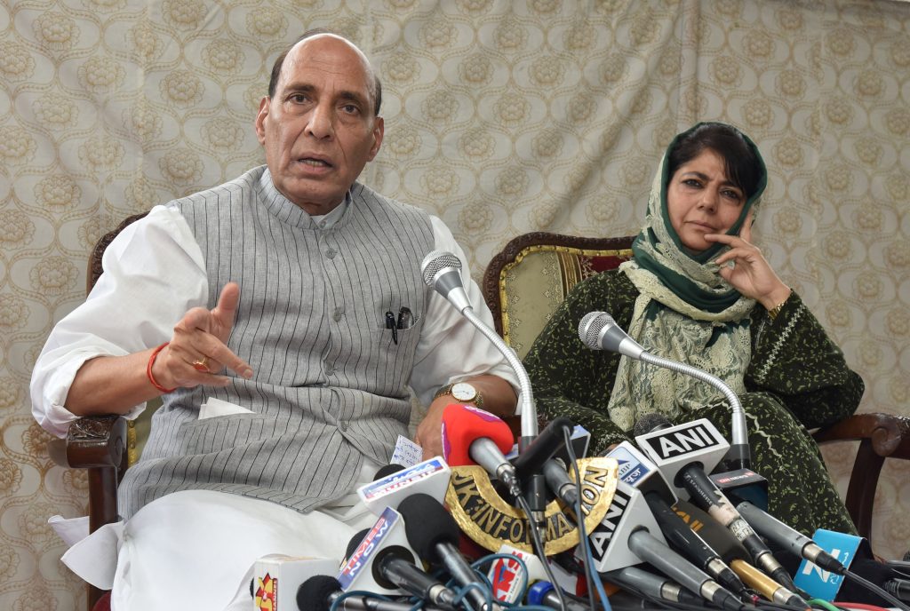 Mehbooba Mufti in a headscarf seated beside Rajnath Singh at a press conference