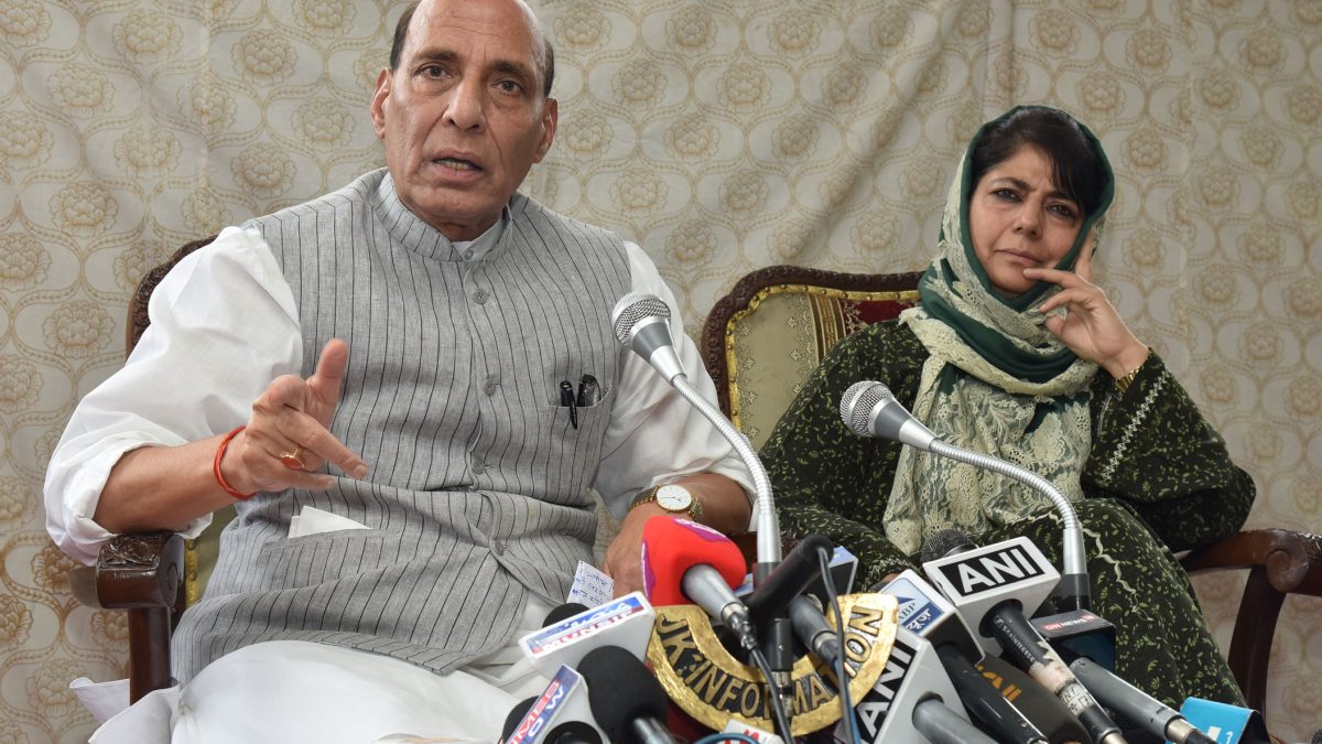 Mehbooba Mufti in a headscarf seated beside Rajnath Singh at a press conference
