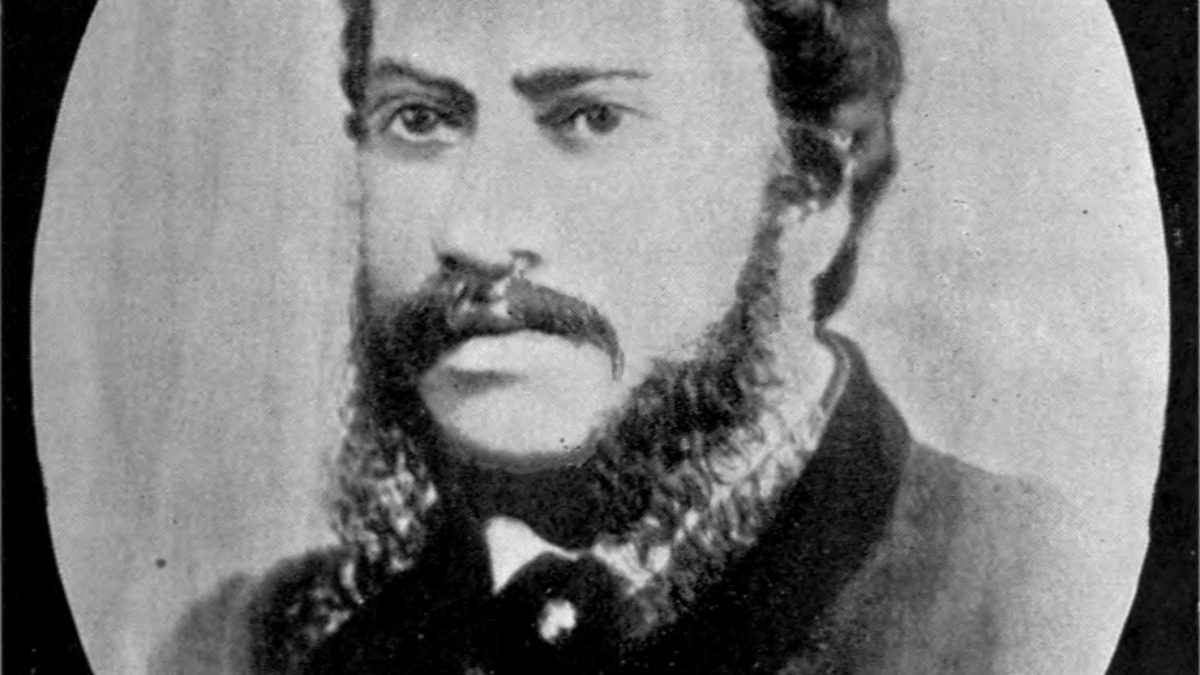 Oval portrait of Michael Madhusudan Dutt with long side-whiskers, in a dark coat