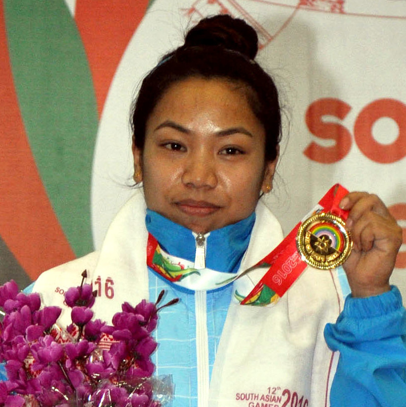 Mirabai Chanu holding a gold medal and a bouquet