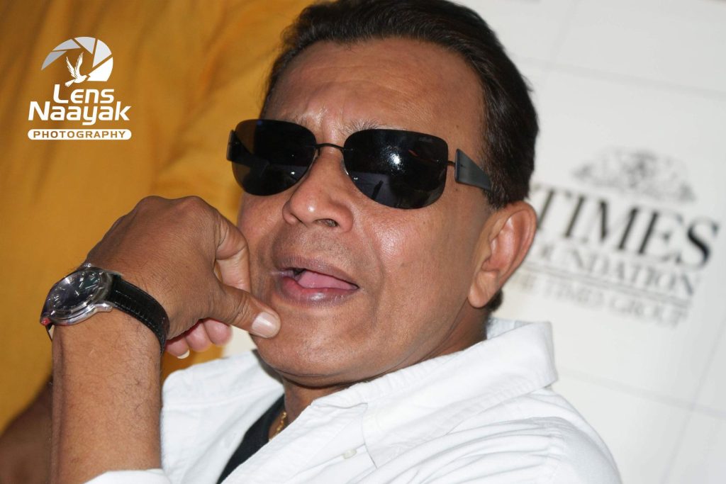 Close-up of Mithun Chakraborty in dark glasses and a white shirt