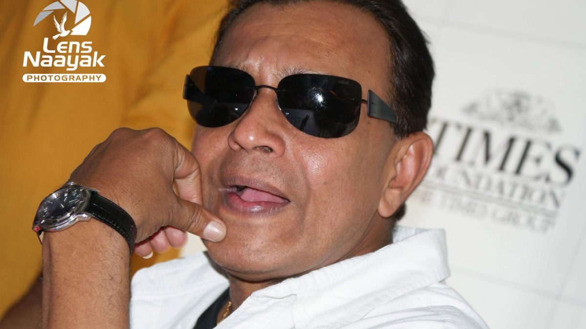 Close-up of Mithun Chakraborty in dark glasses and a white shirt