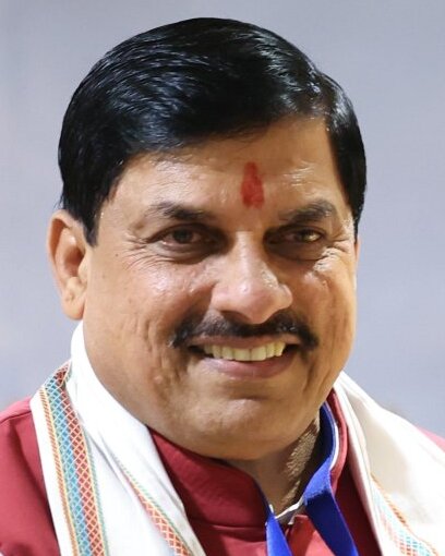 Mohan Yadav smiling, with a tilak and a white stole