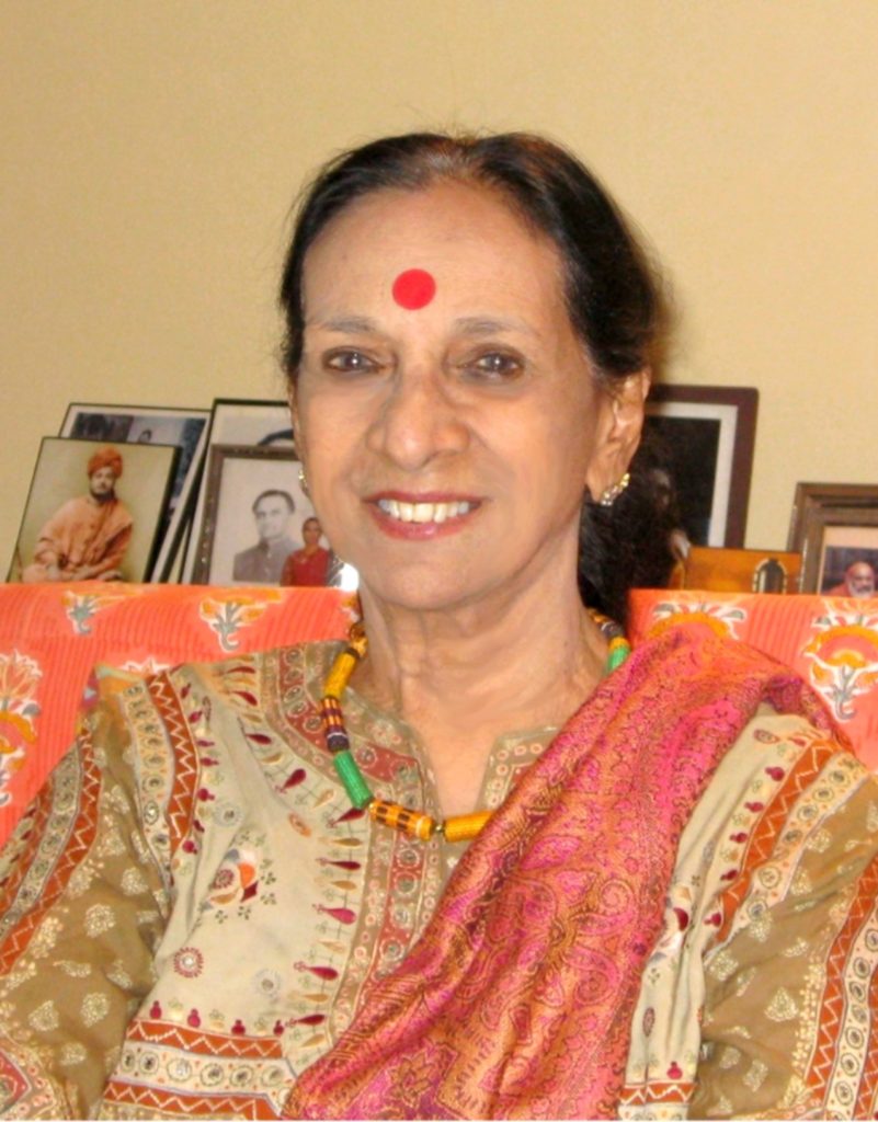 An elderly Mrinalini Sarabhai with white hair, smiling