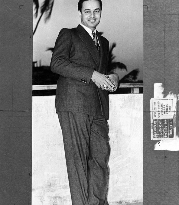A black-and-white photograph of the singer Mukesh standing in a suit