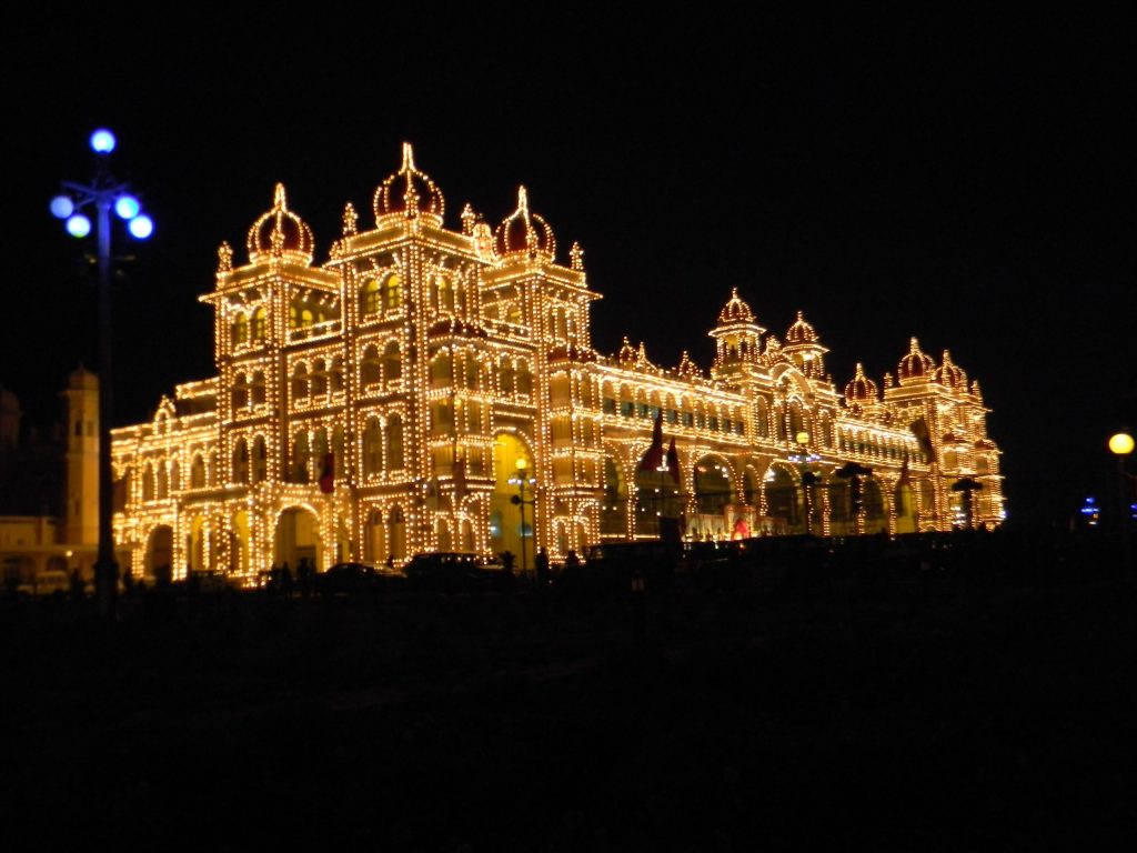 Mysore Palace lit up with thousands of lights at night during Dasara