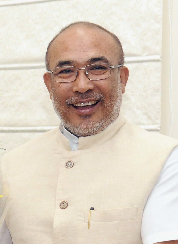 N. Biren Singh in glasses and a cream waistcoat, smiling