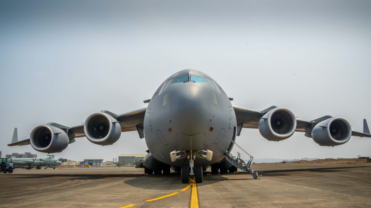 A grey Indian Air Force C-17 Globemaster transport aircraft seen head-on on a runway