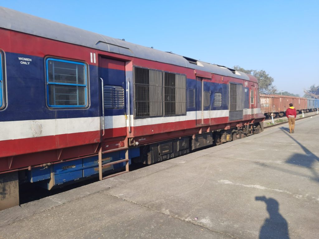 The driving power car of an Indian Railways DEMU train standing at a platform
