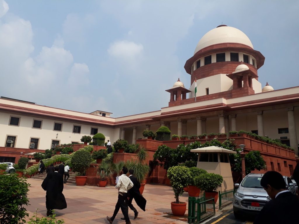 The domed main building of the Supreme Court of India seen across its lawn