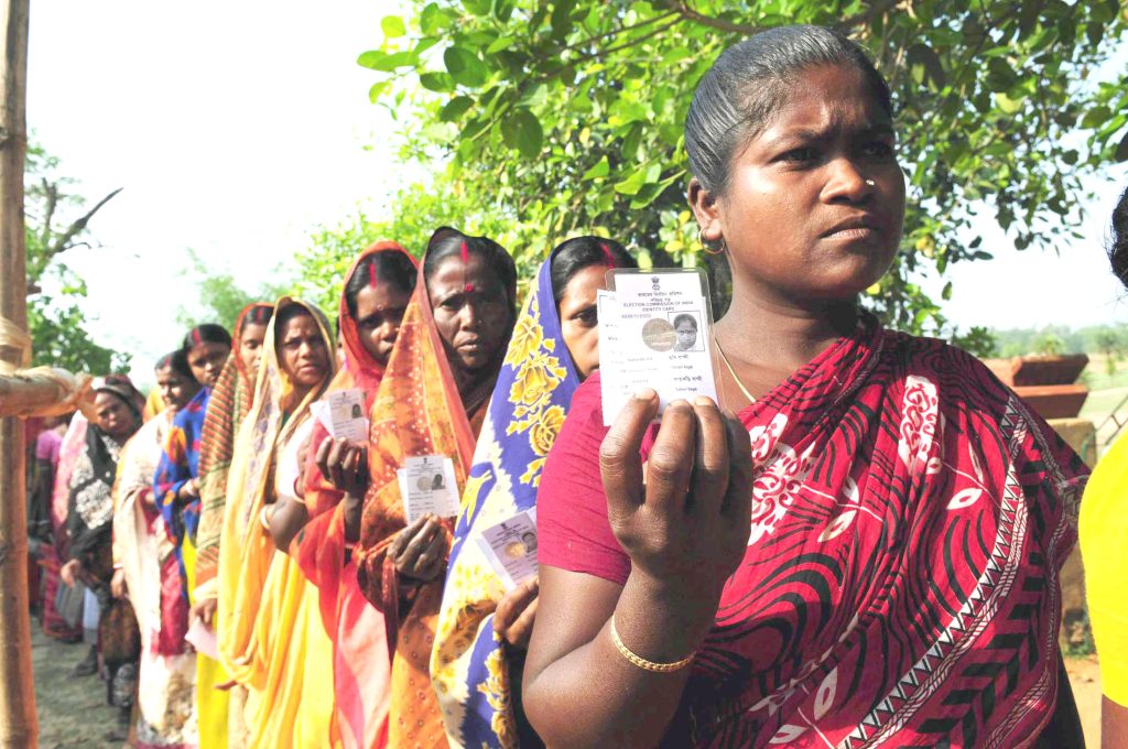 Women voters standing in a queue outside a polling station in a village in Birbhum district, West Bengal