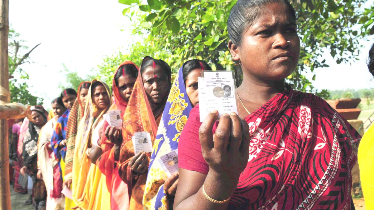 Women voters standing in a queue outside a polling station in a village in Birbhum district, West Bengal