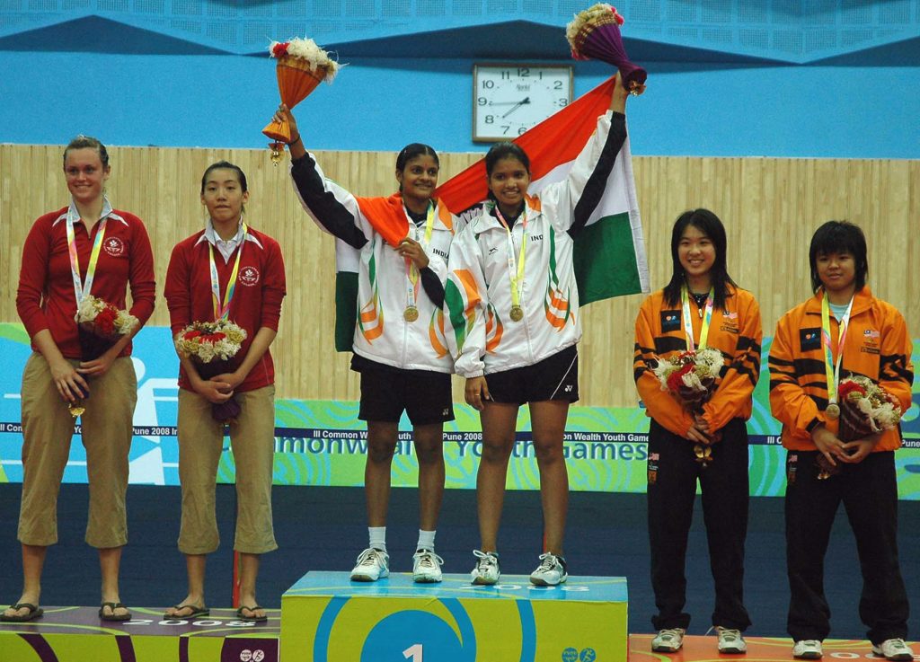 Two Indian badminton players on court after winning a doubles medal