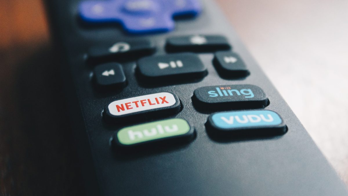 A TV remote control with a Netflix button